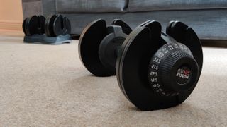 MuscleSquad 32 5kg Adjustable Dumbbell on a living room floor