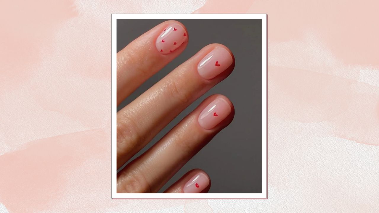 A close-up of a hand with red and pink nails with heart designs by nail artist, Mateja Novakovic (@matejanova) / in a pink and watercolour paint-style template