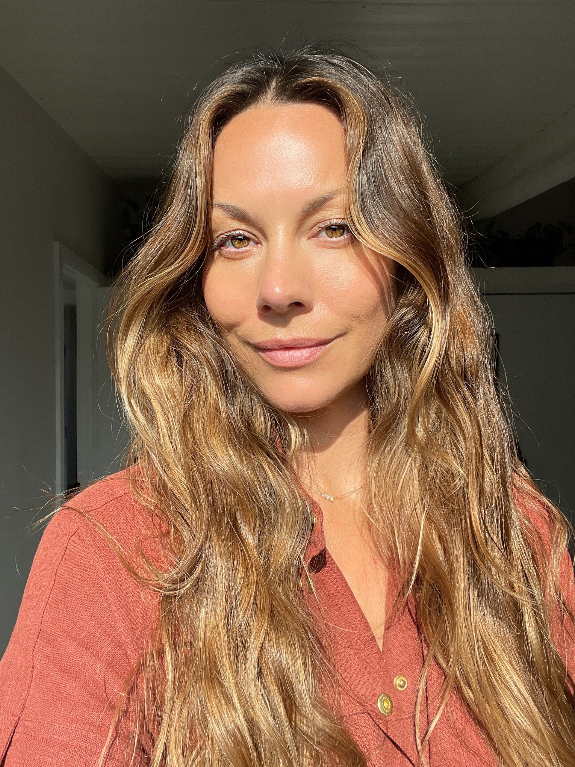 a white woman with long brown hair in a red shirt