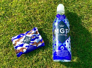 MGP Bottle and Cookie lying on grass