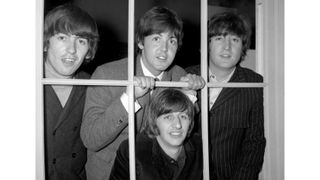 TWICKENHAM - DECEMBER 1965: (L-R) English musician, singer, songwriter and guitarist George Harrison (1943-2001), English singer, songwriter and bassist Paul McCartney, English singer, songwriter and guitarist John Lennon (1940-1980), and English musician, singer and drummer Ringo Starr (below), at Twickenham Studios promoting the release of The Beatles' "Rubber Soul" during December 1965 in London, UK