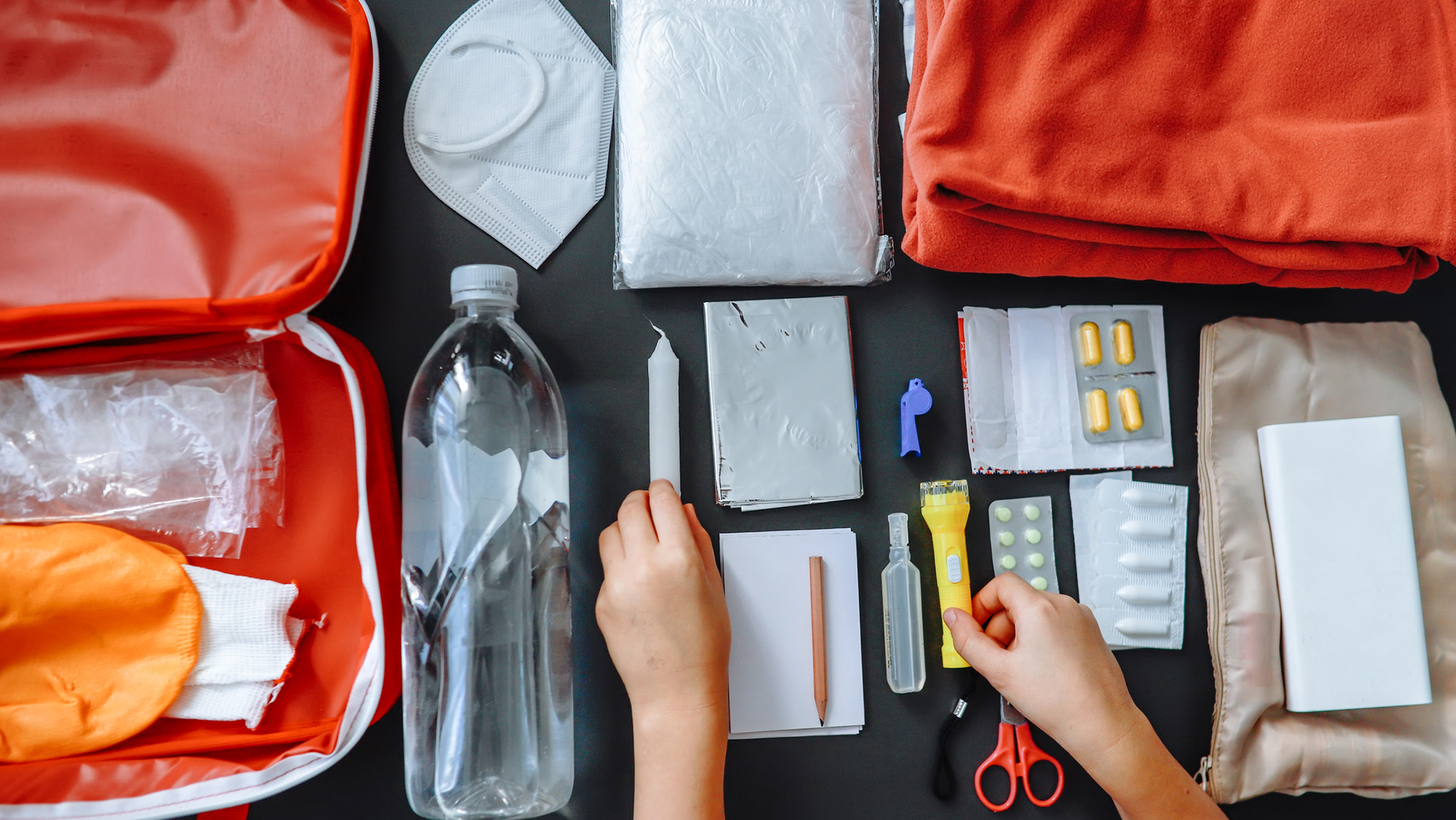A close up of a disaster kit on a dark surface