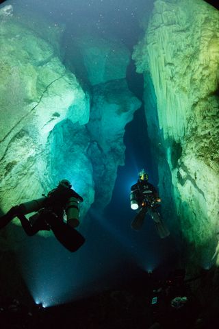 A shot of divers Kenny Broad and Brian Kakuk navigating through Stargate Cave, on Andros Island, Bahamas. The image comes from National Geographic's new documentary series "One Strange Rock."