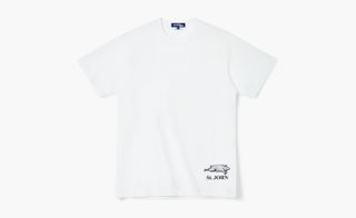 View of a white St JOHN t-shirt featuring their pig logo and brand name underneath. The t-shirt is laid out flat on a light coloured background