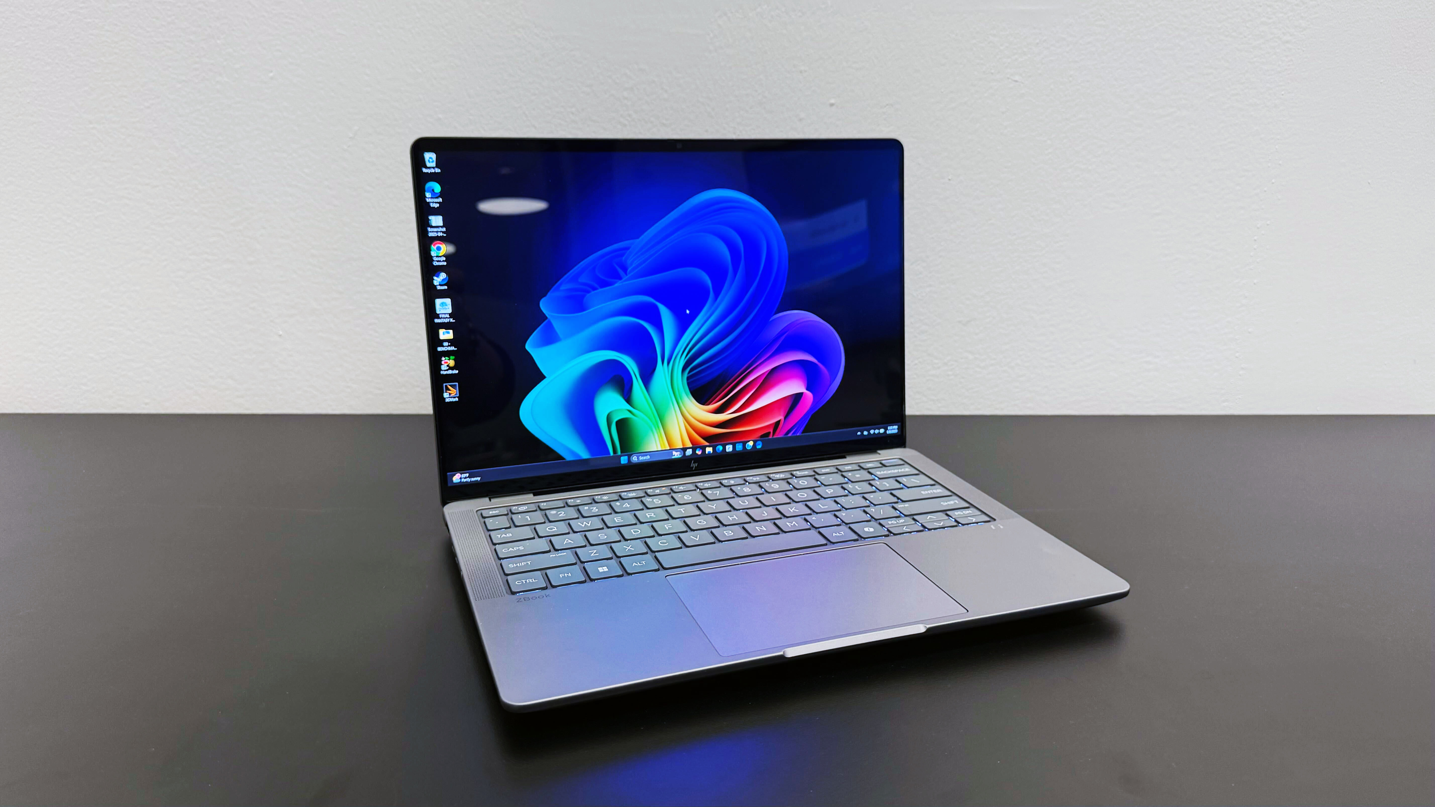 The HP ZBook Ultra 14 G1a mobile workstation open on a black desk against a white wall.