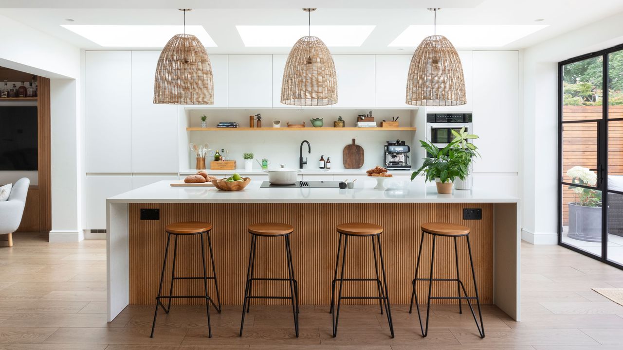 White kitchen and worktop with kitchen island and bar stools