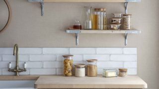 kitchen with wooden worktops and open shelving with storage jars