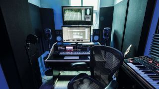 A home recording studio setup with acoustic treatment on the walls