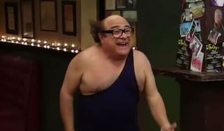 Danny DeVito dressed up in a wrestling outfit.