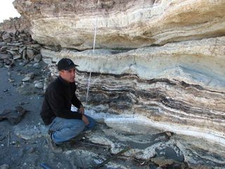 High levels of iridium found in black mats seen at Rio Salado in Chile's Atacama Desert suggested a cosmic origin. But new tests by Jeff Pigati (shown here) and colleagues show these iridium mats occurred at various times and are instead likely the result