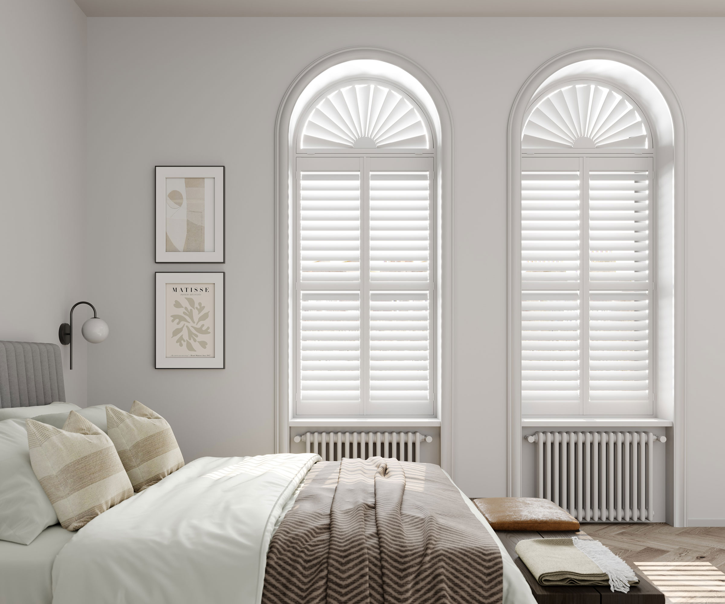 tall arched sash windows in bedroom with white shutters