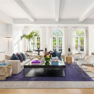 living room with bright white walls and large white windows