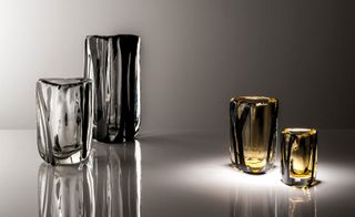 Two silver and black, and two gold and black vases