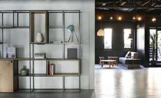 Grey room separator with industrial-style shelving, looking through to the seating area