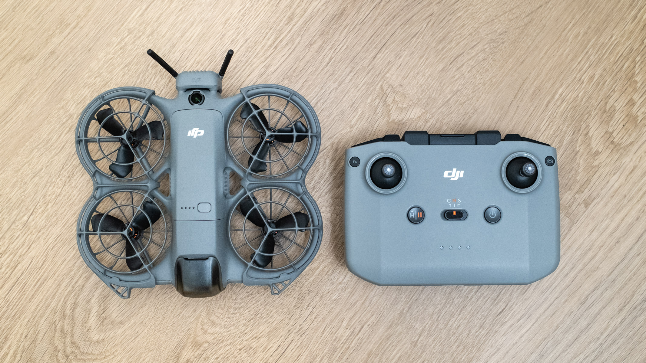 DJI Neo 2 and controller on a wooden floor