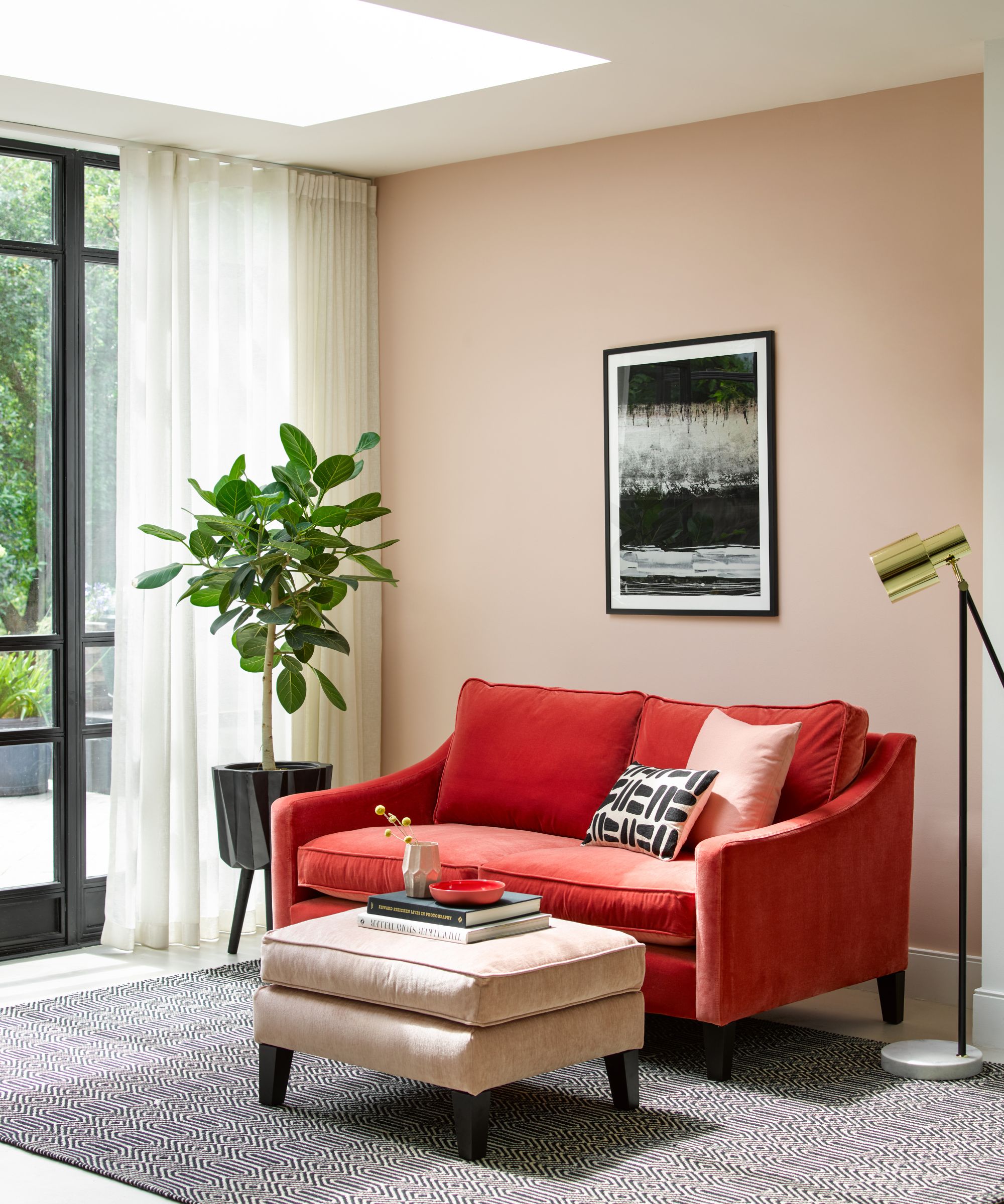 Living room with red sofa and pink walls