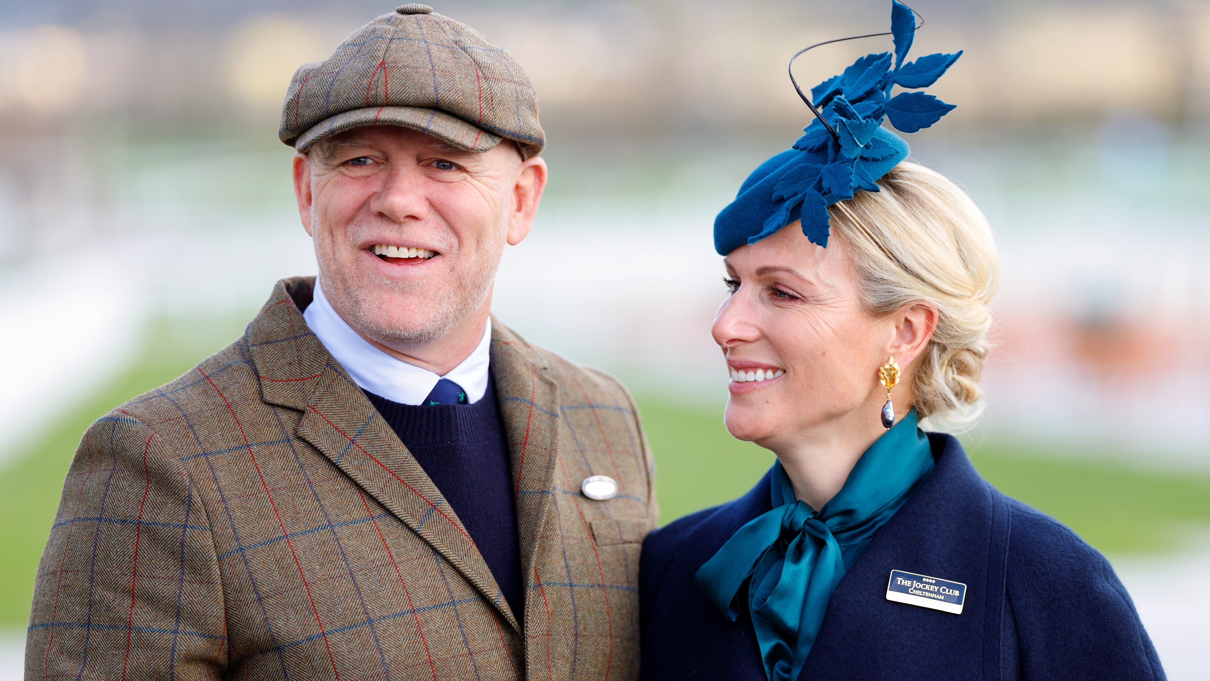 Mike Tindall and Zara Tindall smile for photos as they attend day 1 'Champion Day' of the Cheltenham Festival 