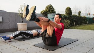 Man and woman perform alekna core exercise