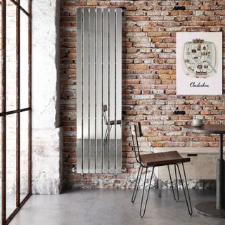 mirrored vertical radiator on exposed brick wall in industrial style kitchen