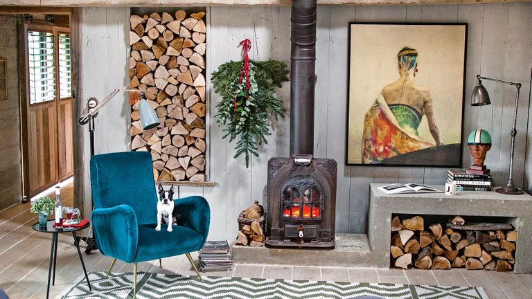Cozy living room with log pile and wood burning stove