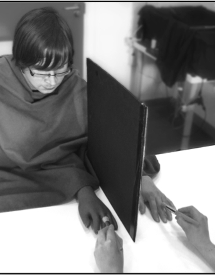 A light-skinned participant experiences a dark hand as part of his own body.
