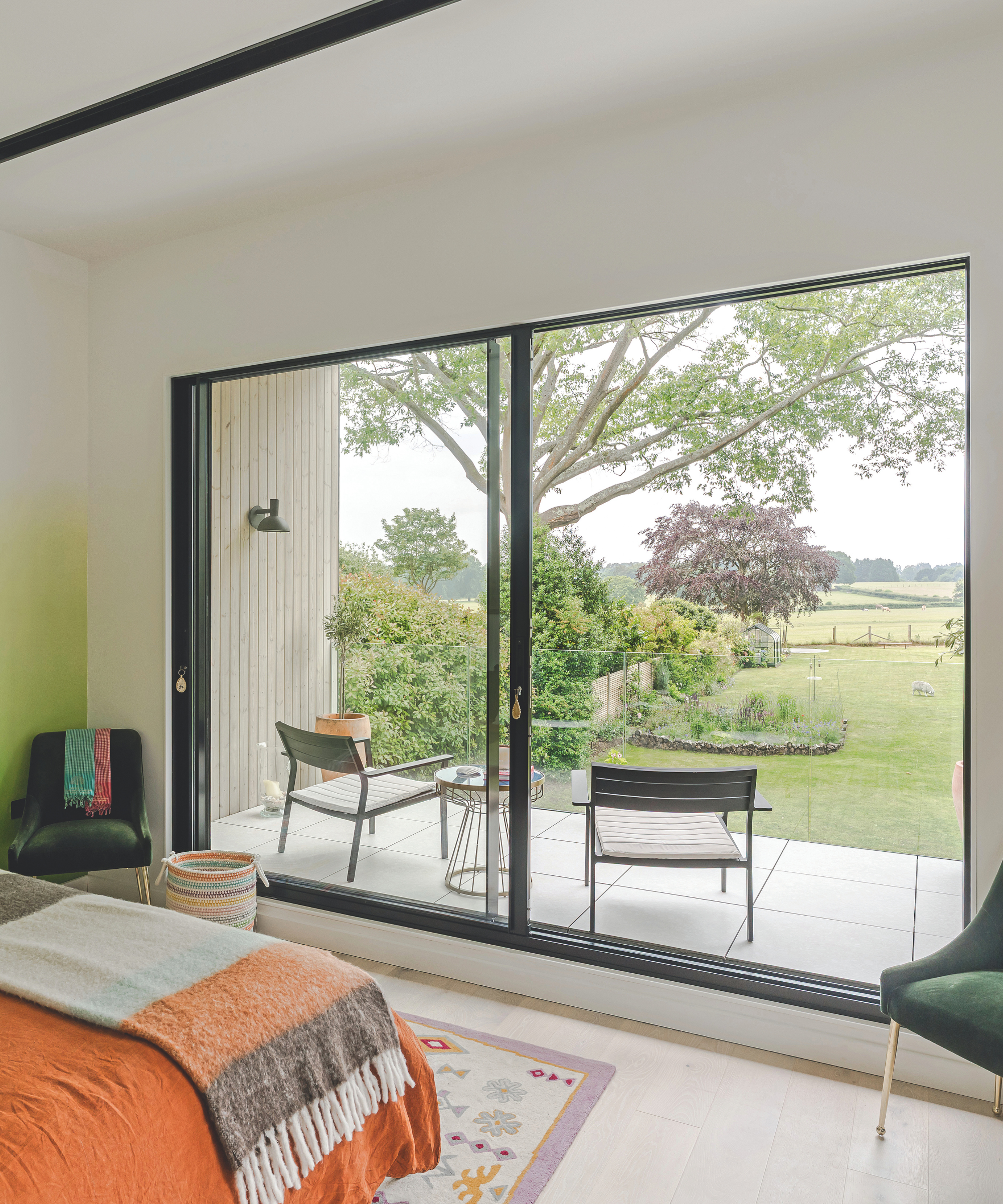 Bedroom with floor to ceiling patio with terrace overlooking the garden