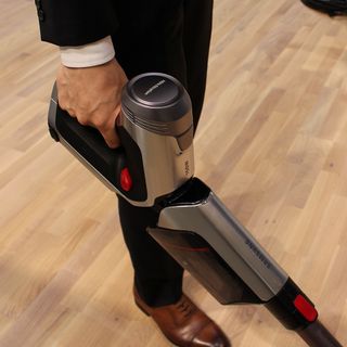 Using vacuum cleaner on wooden flooring for cleaning