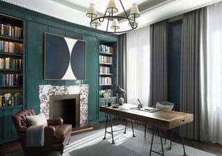 Dark green office with marble and brass coloured fireplace with matching frame