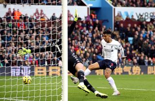 Liverpool’s Roberto Firmino scores a goal before it is disallowed by VAR