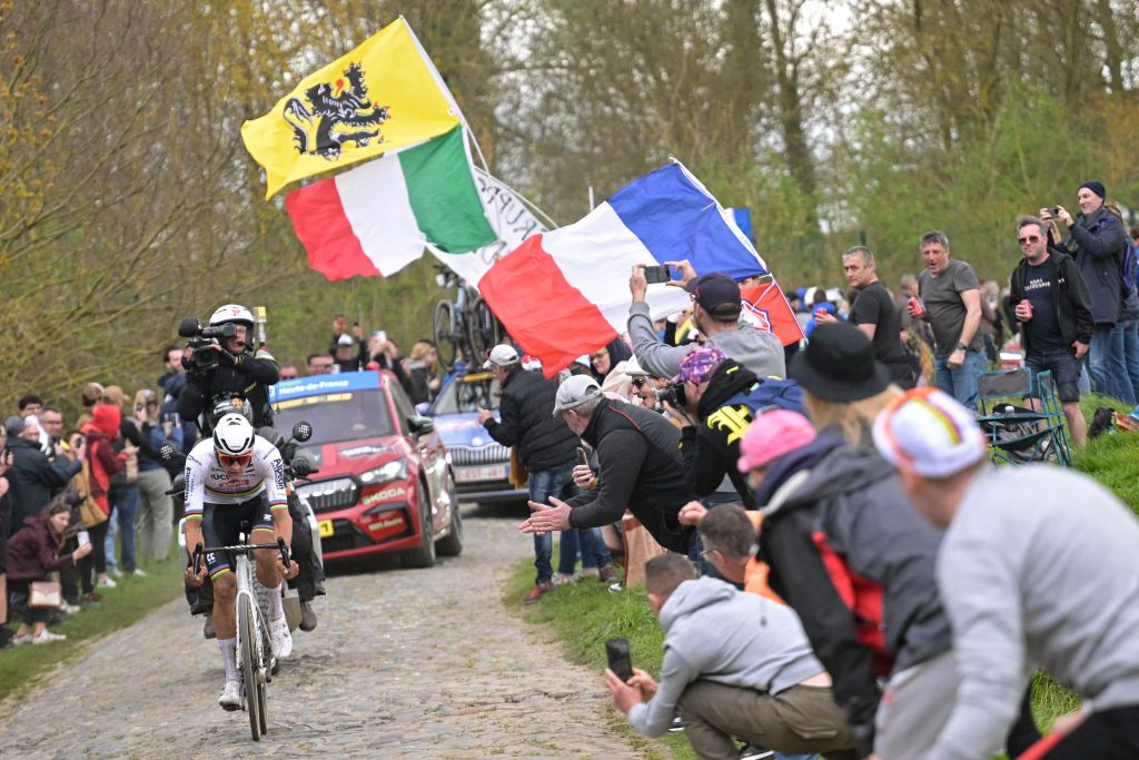 Alpecin - Deceuninck team's Dutch rider Mathieu Van Der Poel cycles in a lone breakaway ahead of the pack of riders on a cobblestone sector during the 121st edition of the Paris-Roubaix one-day classic cycling race, 260km between Compiegne and Roubaix, northern France, on April 7, 2024. (Photo by Bernard PAPON / POOL / AFP)