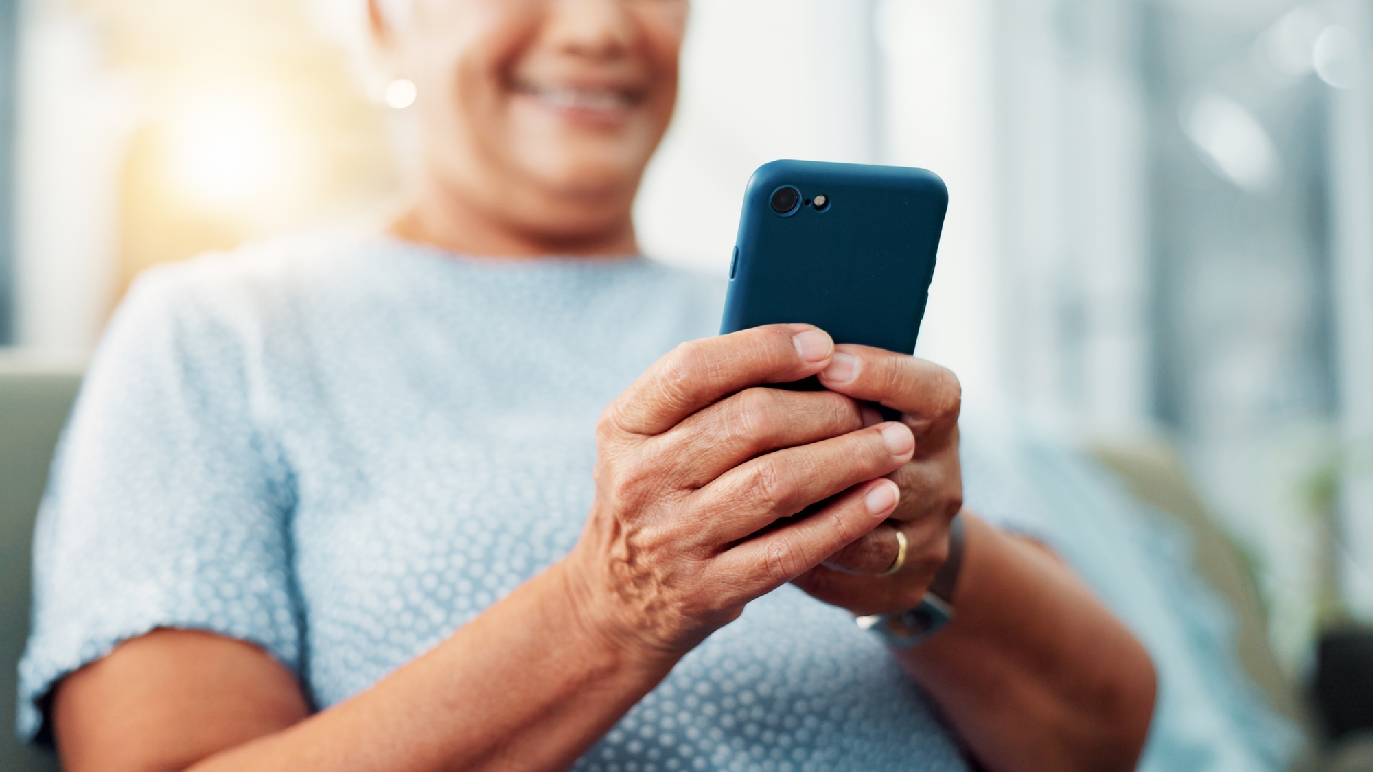 elderly woman holding smartphone