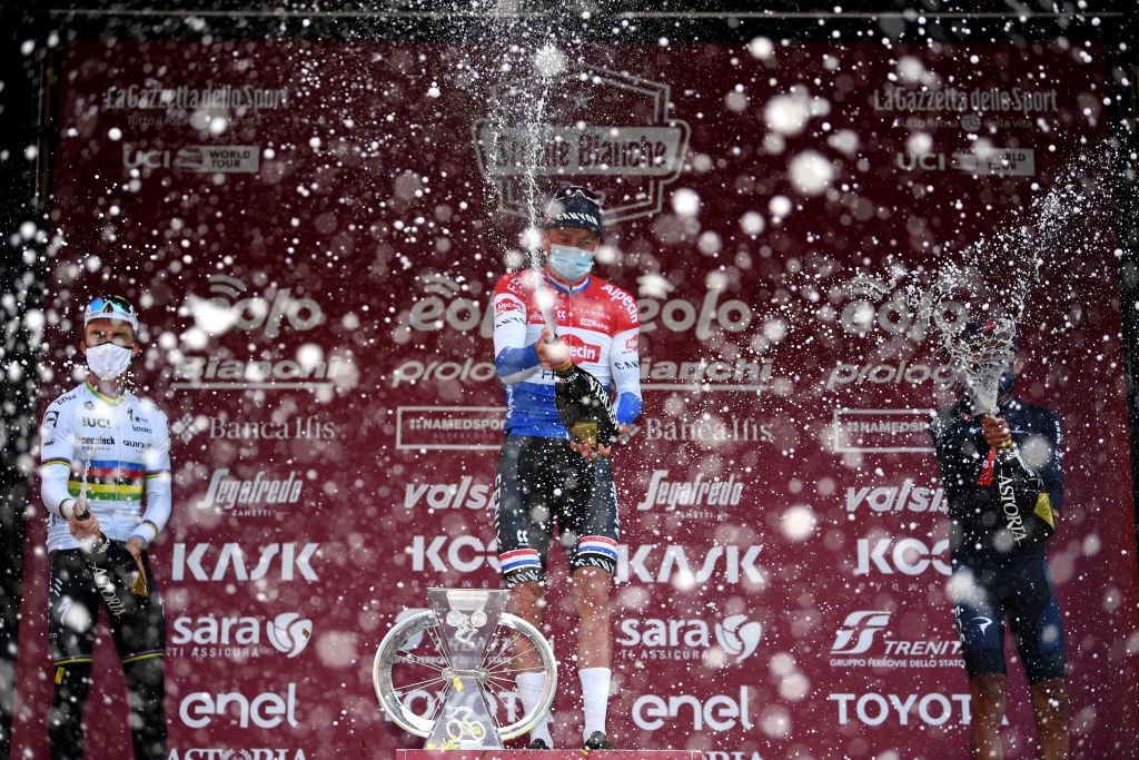 SIENA ITALY MARCH 06 Podium Julian Alaphilippe of France and Team Deceuninck QuickStep Mathieu Van Der Poel of Netherlands and Team AlpecinFenix Egan Arley Bernal Gomez of Colombia and Team INEOS Grenadiers Celebration during the Eroica 15th Strade Bianche 2021 Mens Elite a 184km race from Siena to Siena Piazza del Campo Trophy Champagne Mask Covid Safety Measures StradeBianche on March 06 2021 in Siena Italy Photo by Tim de WaeleGetty Images