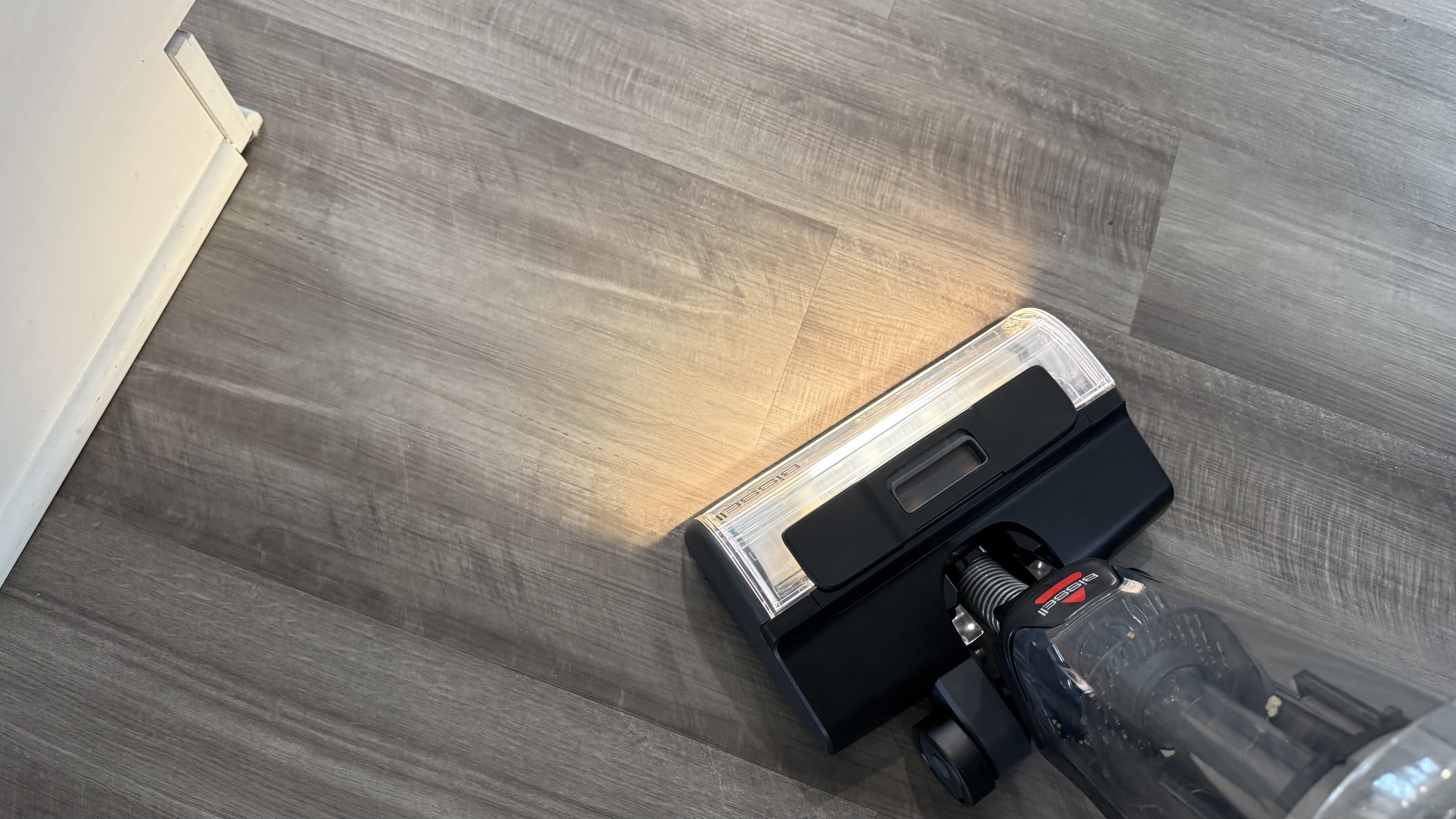 Bissell CrossWave HydroScrub All-in-One-Multi-Surface Cleaner vacuuming up crumbs