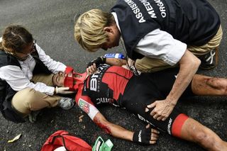 Richie Porte is attended by medical staff after crashing during stage 9 at the Tour de France