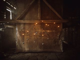 A copper chandelier inside a barn