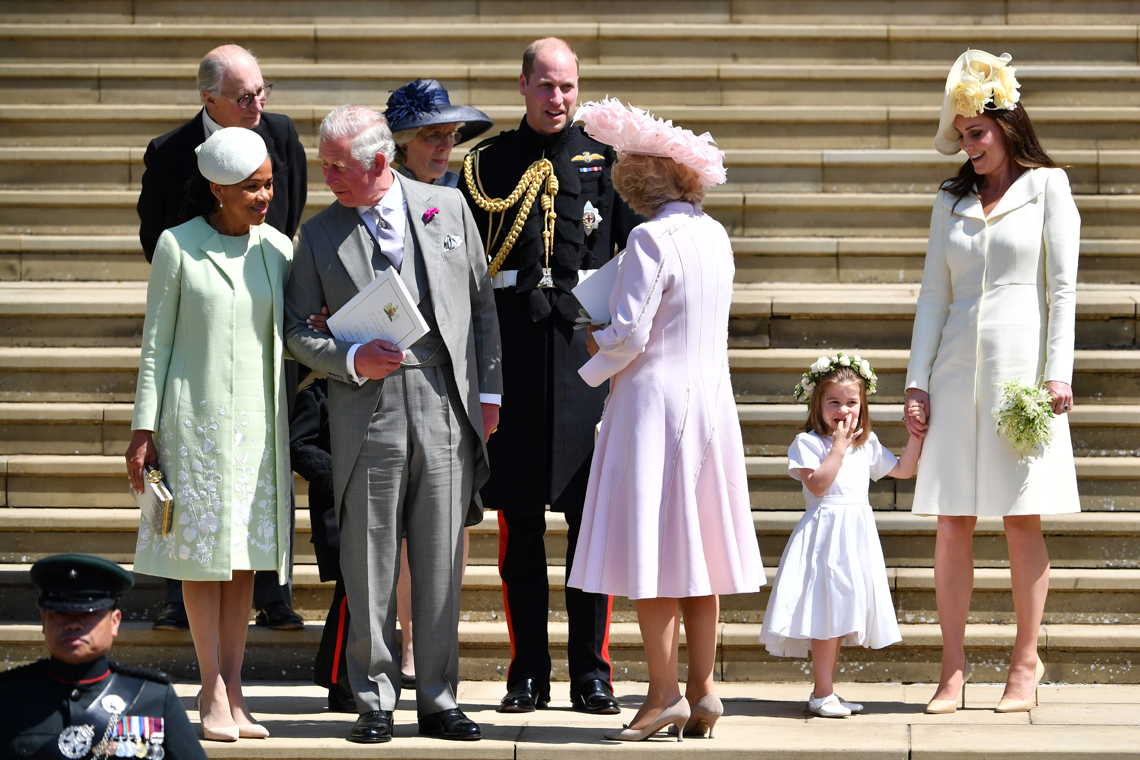 Doria Ragland talking to King Charles after Harry and Meghan's wedding, surrounded by Prince William, Princess Kate, Queen Camilla and Princess Charlotte