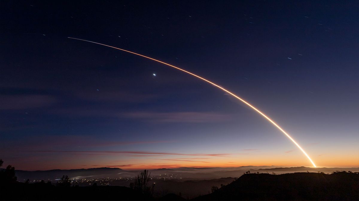 the bright streak of a rocket&#039;s thrust across the night sky above southern California in a time lapse exposure