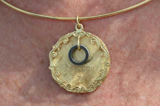 Laura Shepard Churchley's gold pendant featuring a washer flown as part of her father's Freedom 7 Mercury spacecraft, is set to fly into space again, this time with Churchley aboard Blue Origin's New Shepard rocket on Dec. 9, 2021.