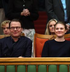 Princess Estelle and Prince Daniel sitting next to each other watching a tennis match