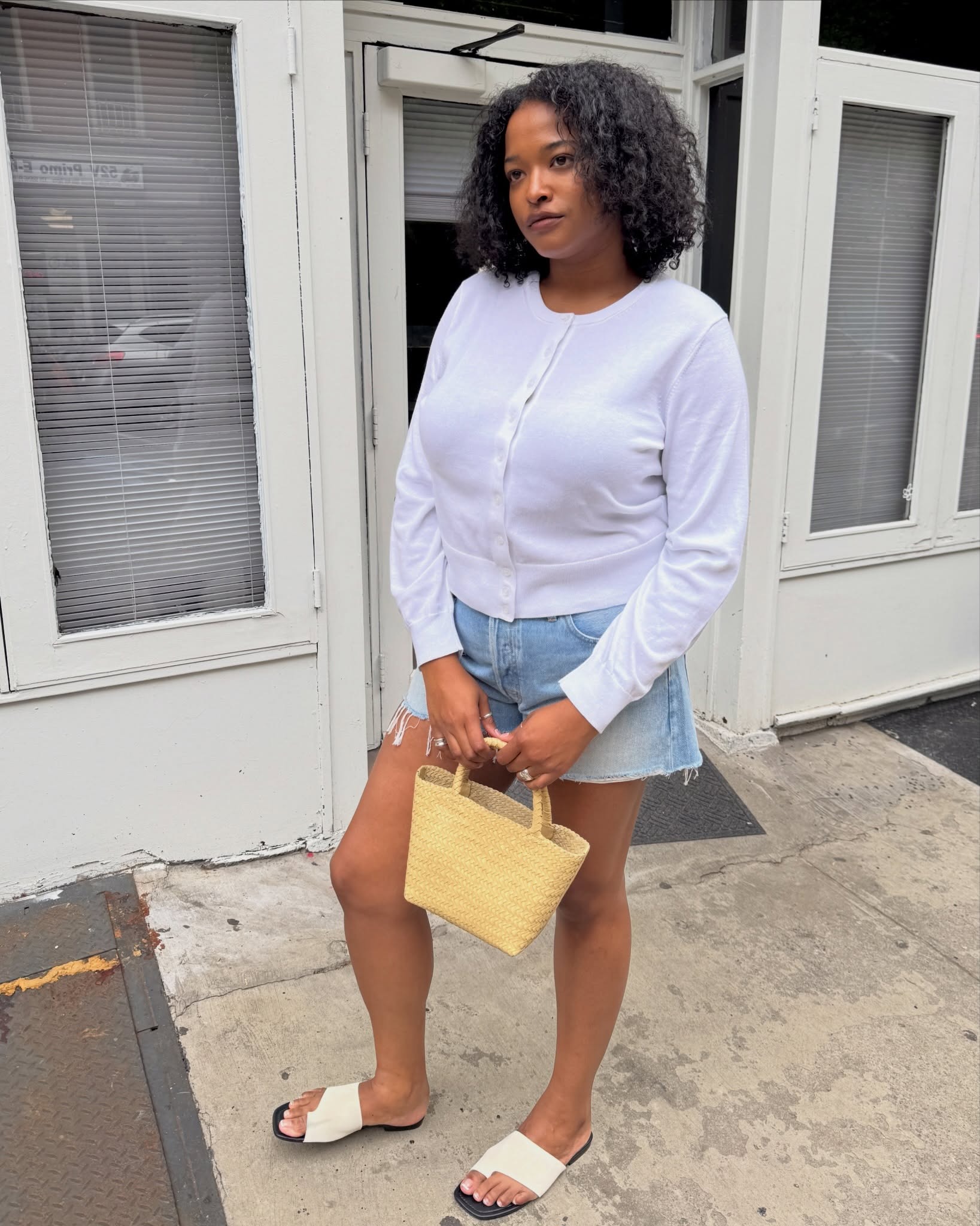 Woman in a cardigan and denim shorts