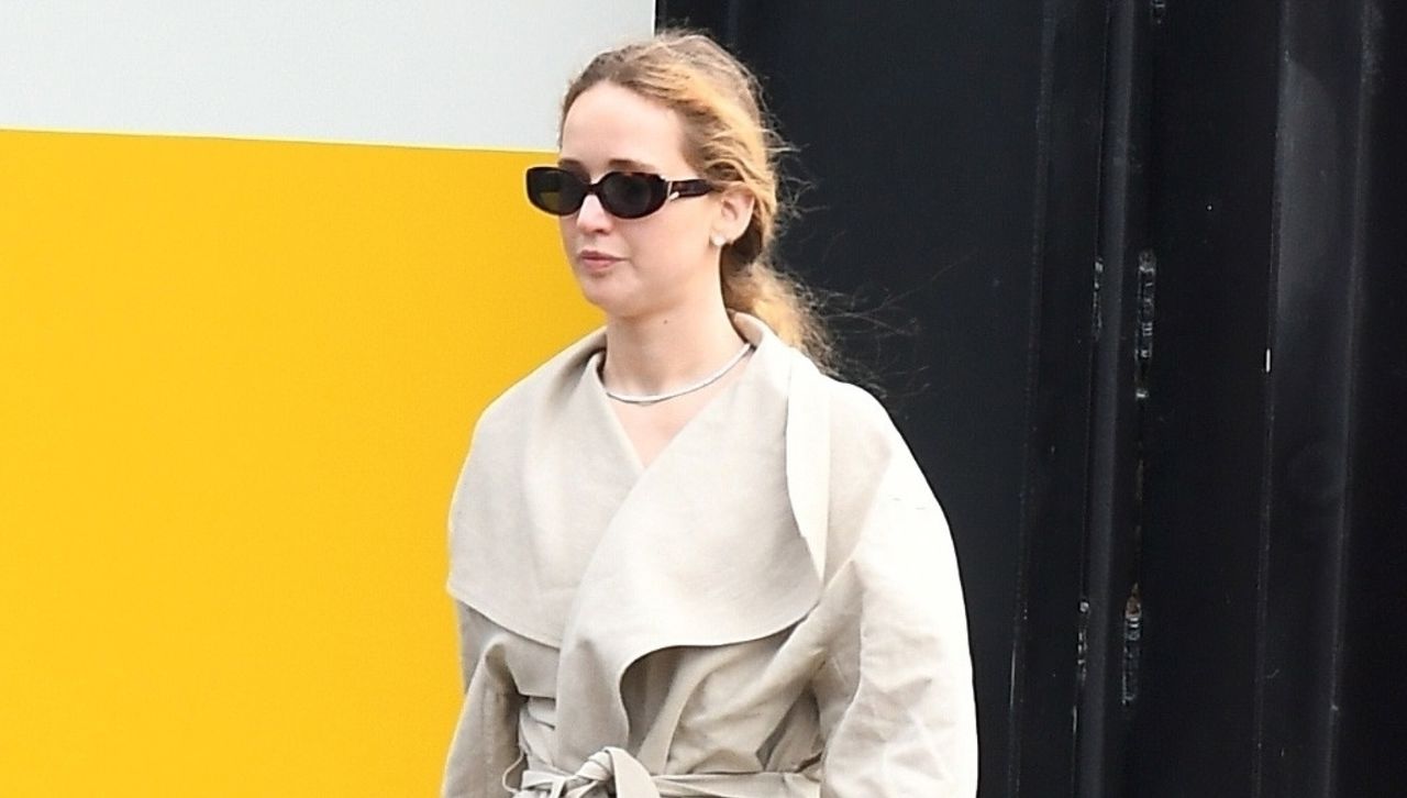 Jennifer Lawrence wearing a wrap coat with a diamond tennis necklace sunglasses and on sale nike sneakers