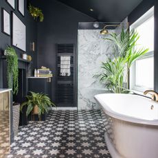 bathroom with black walls and white bath tub