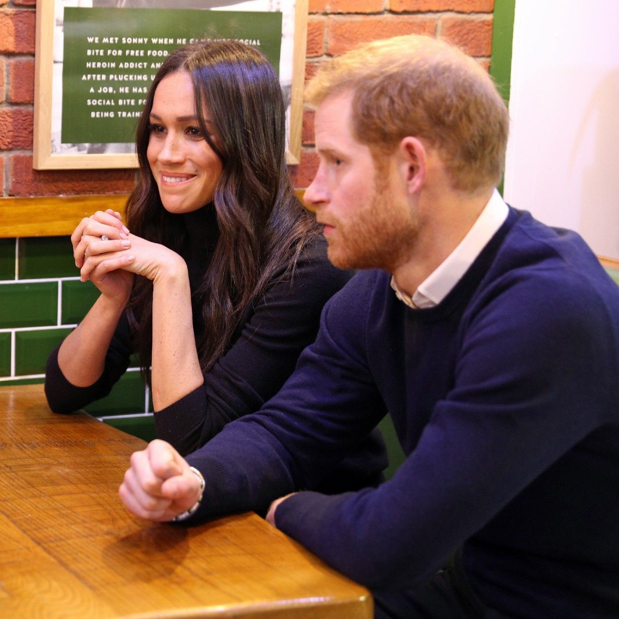 Britain&#039;s Prince Harry (R) and his fiancée US actress Meghan Markle speak to members of staff on a visit to Social Bite, a business and cafe, during a visit to Scotland on February 13, 2018. Social Bite runs social enterprise cafés throughout Scotland and use this platform to distribute 100,000 items of food and hot drinks to homeless people each year, as well as employing staff who have experienced homelessness themselves. 