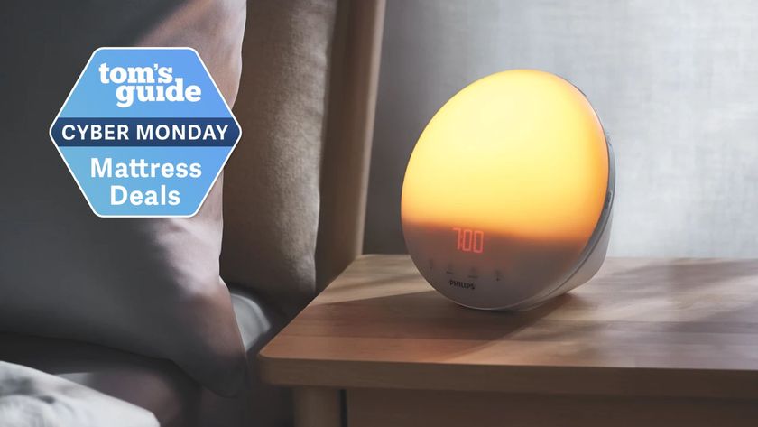 The image shows the Philips SmartSleep and Wake-Up Light in a dimly lit bedroom