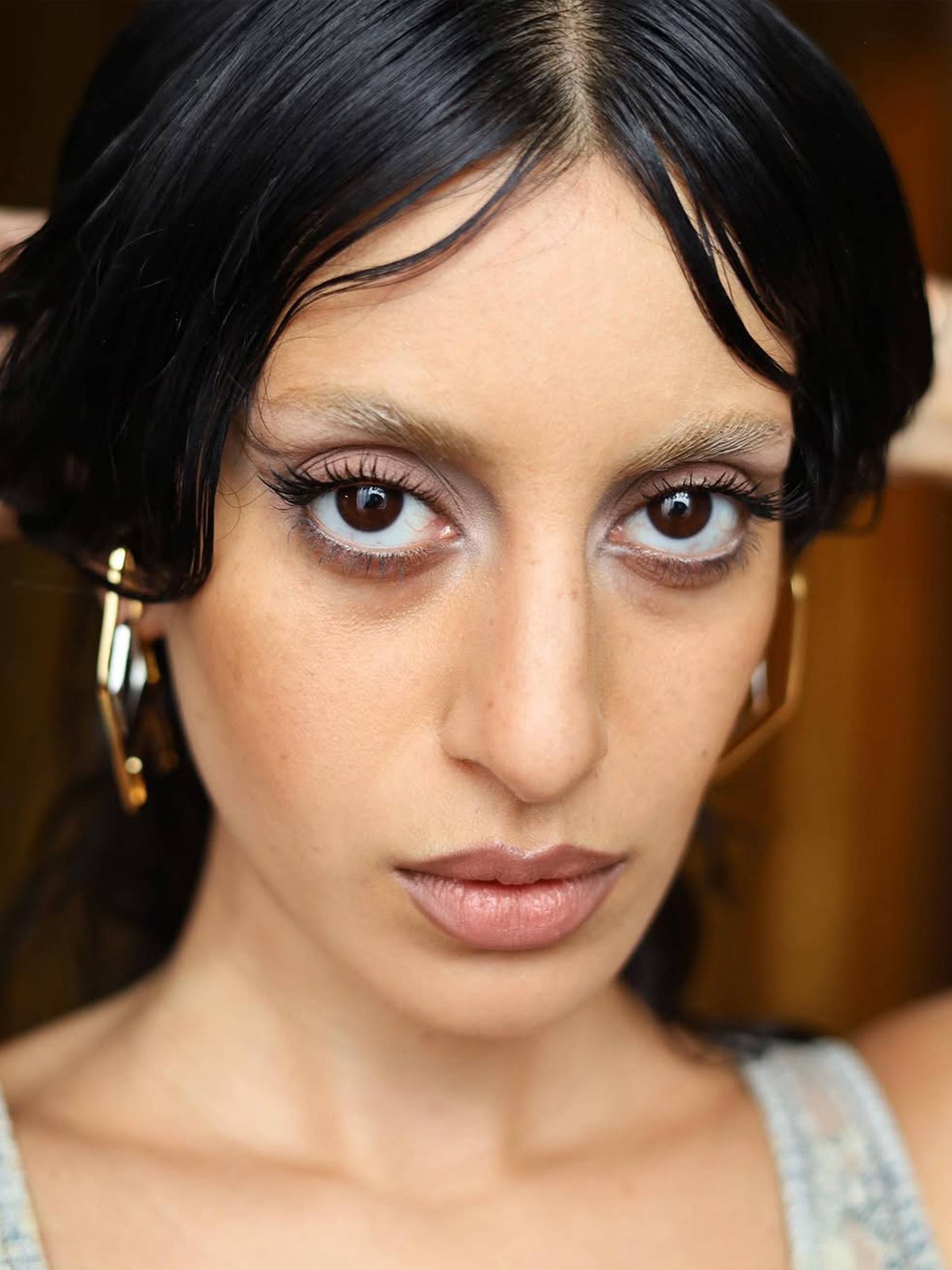 Anaa Saber with bleached brows and sheer, white eyeshadow with nude-colored lips