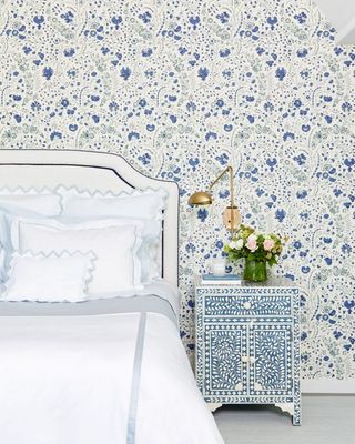 Blue bedroom with pretty blue wallpaper and bone inlay blue side table