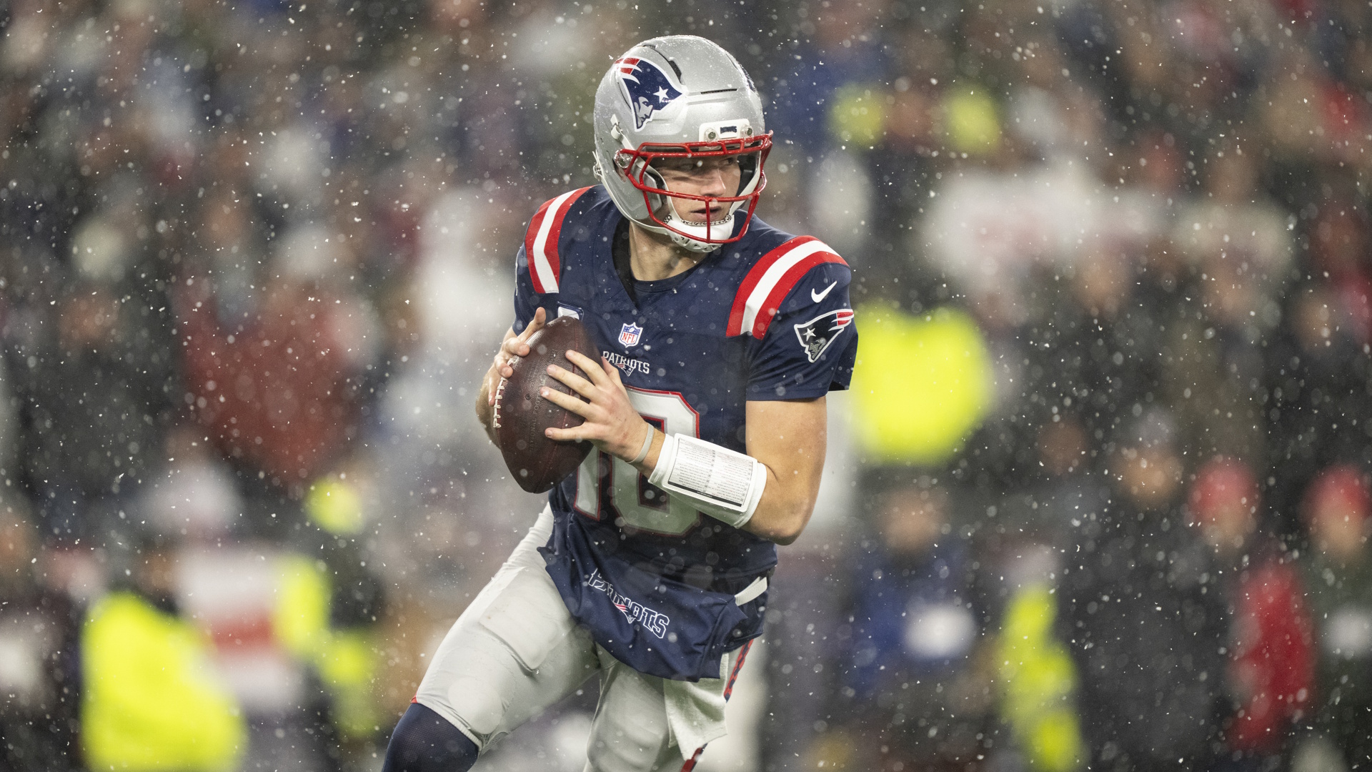 Drake Maye of the New England Patriots looks to pass during an NFL Playoff game.