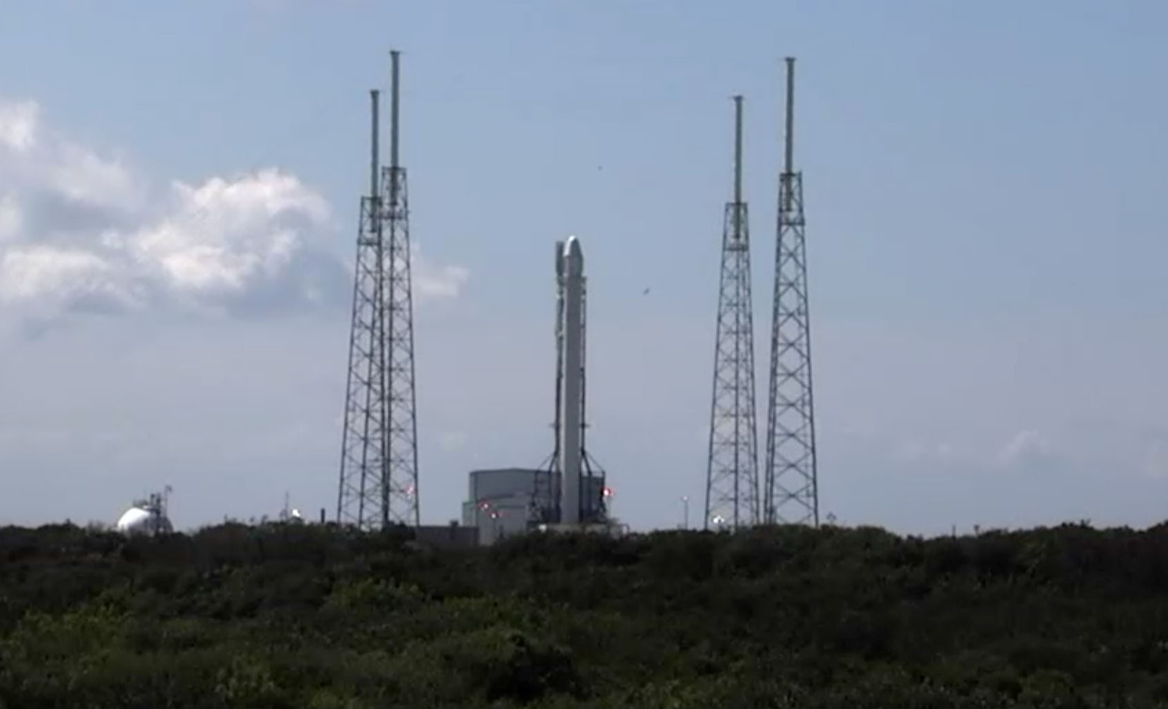 A SpaceX Falcon 9 rocket and its unmanned Dragon space capsule stand atop a launch pad at Cape Canaveral Air Force Station in Florida ahead of a planned Sept. 20, 2014 launch. The Dragon spacecraft is carrying 2.5 tons of cargo to the International Space 