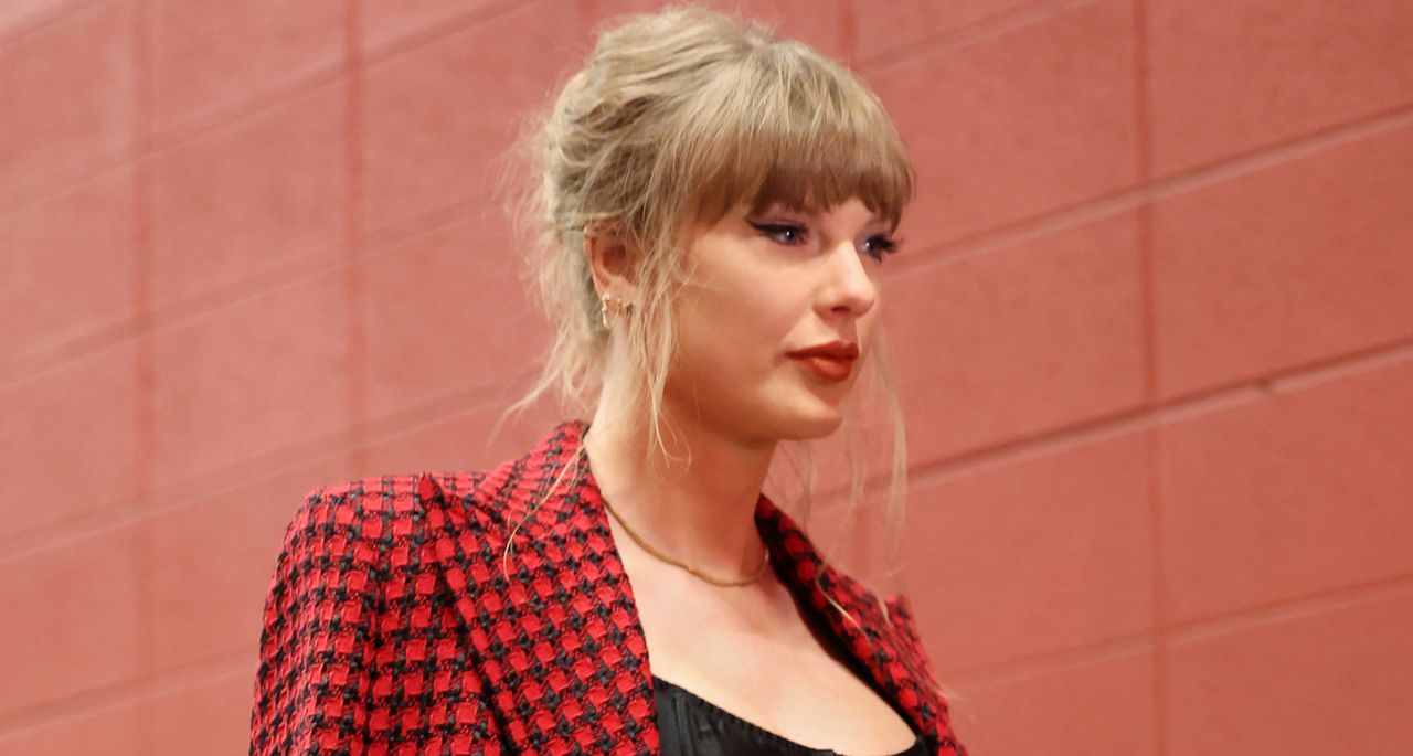 Taylor Swift walks into Arrowhead stadium for the chiefs game wearing a red plaid versace skirt suit