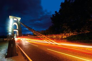 Turn moving traffic into artistic light trails using long exposures after dark